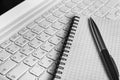Notebook and Pen on Laptop Keypad Royalty Free Stock Photo