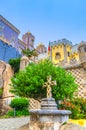 Pena Palace with colorful decorative walls, towers and stone cross, Palacio Nacional da Pena Romanticist castle