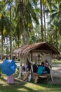 A Malays family rest at wooden hut coconut farm.