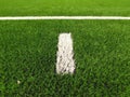 Penalty area. White line on artificial grass field on football playground. Detail of a cross of painted white lines Royalty Free Stock Photo