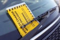 Penalty charge notice parking fine attached to windscreen