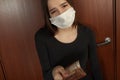 Penalty for violation of quarantine and self-isolation with coronavirus. Sad young woman in a medical mask holds in her hands Royalty Free Stock Photo