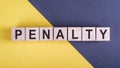 PENALTY word made with wooden blocks on yellow ang gray desk Royalty Free Stock Photo