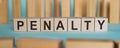 PENALTY Word Written In Wooden Cubes on blue background