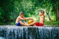 Penampang,Sabah-Oct 29,2016:Happy funny Asian kids playing water on river with palm tree tropical background in the countryside of Royalty Free Stock Photo