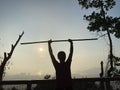 Penang, Malaysia - August 23, 2020 : A health enthusiast lifting a custom made weights in the morning sun at Bukit Jambul