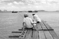 Penang, Malaysia, December 19 2017: Two Fishermen waiting for the catch of the day