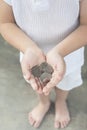 Penang, Malaysia - January 14, 2020 : Closed up of small asian boy hand holding handful of Malaysia coins.Concept of saving and