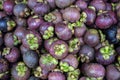 Closeup heaps of fresh mangosteen fruits.Mangosteen has been known as