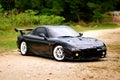 Penang, Malaysia - January 12, 2021 : View of a black Mazda RX-7 original specification with trees in the background at Gelugor, P