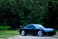 Penang, Malaysia - January 12, 2010 : View of a black Mazda RX-7 original specification with trees in the background at Gelugor, P