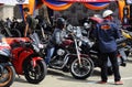 Motorcyclists ride high-powered motorcycles through crowded areas.