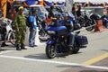 Motorcyclists ride high-powered motorcycles through crowded areas.