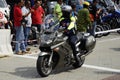 Motorcyclists ride high-powered motorcycles through crowded areas.