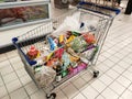 Groceries that have been picked up are placed in the cart before payment is made at the payment counter.