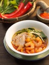 Penang Prawn Mee soup with pork, vegetables, red chili and shrimp in white bowl Royalty Free Stock Photo