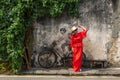 Penang street art - lady in red in front the little boy with the motor bike