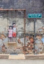 Penang wall artwork named Children on the Swing