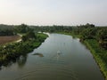 Aerial view boats move at Sungai Perai near rural area.