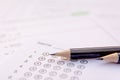 Pencil on answer sheets or Standardized test form with answers bubbled. multiple choice answer sheet Royalty Free Stock Photo