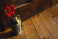 Pencil box full of pencil and scissors on the wooden floor Royalty Free Stock Photo