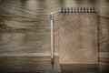 Pencil brown notebook on wooden board