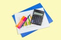 Pencil, calculator, Blue file, graph sheet, Color highlight pen on white yellows isolated Royalty Free Stock Photo