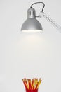 Pencil Case Below A Lamp Royalty Free Stock Photo