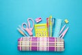 Pencil case and school supplies on blue background. Back to school concept Royalty Free Stock Photo