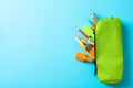 Pencil case with school supplies on blue background Royalty Free Stock Photo