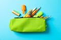 Pencil case with school supplies on blue background Royalty Free Stock Photo