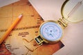 Pencil, compass and vintage map on a wooden table. Royalty Free Stock Photo