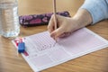 Hand student testing in exercise and taking fill in exam carbon paper computer sheet with pencil at school test room, education Royalty Free Stock Photo