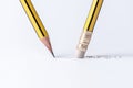 A pencil draws a line on paper and a pencil with an eraser removes a strip.