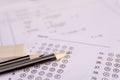 Pencil and eraser on answer sheets or Standardized test form with answers bubbled. multiple choice answer sheet Royalty Free Stock Photo