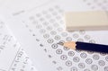 Pencil and eraser on answer sheets or Standardized test form with answers bubbled. multiple choice answer sheet Royalty Free Stock Photo