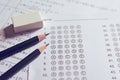 Pencil and eraser on answer sheets or Standardized test form with answers bubbled. multiple choice answer sheet Royalty Free Stock Photo
