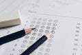 Pencil and eraser on answer sheets or Standardized test form with answers bubbled. multiple choice answer sheet Royalty Free Stock Photo