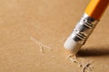 A pencil eraser removing a written mistake on a piece of paper. Royalty Free Stock Photo