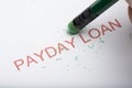 Pencil Erasing the Word `Payday Loan` on Paper