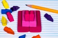 Pencil erasers stacked and scattered on college ruled filler pap Royalty Free Stock Photo