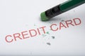 Pencil Erasing the Word `Credit Card` on Paper