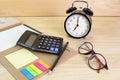 Pencil, folder file, Calculator, glasses clock on wood table concept Office equipment