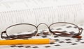 Pencil and glasses on a crossword puzzle Royalty Free Stock Photo