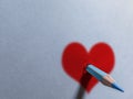 Pencil holing sheet of paper with a heart drawn Royalty Free Stock Photo