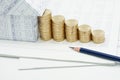 Pencil and house with step pile of gold coins Royalty Free Stock Photo