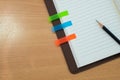 Pencil,note paper and notebook on wooden table. Top view