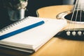 Pencil Notebook on Acoustic guitar for songwriter Royalty Free Stock Photo