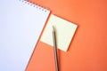 Pencil and notepad on orange background Royalty Free Stock Photo
