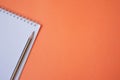 Pencil and notepad on orange background Royalty Free Stock Photo